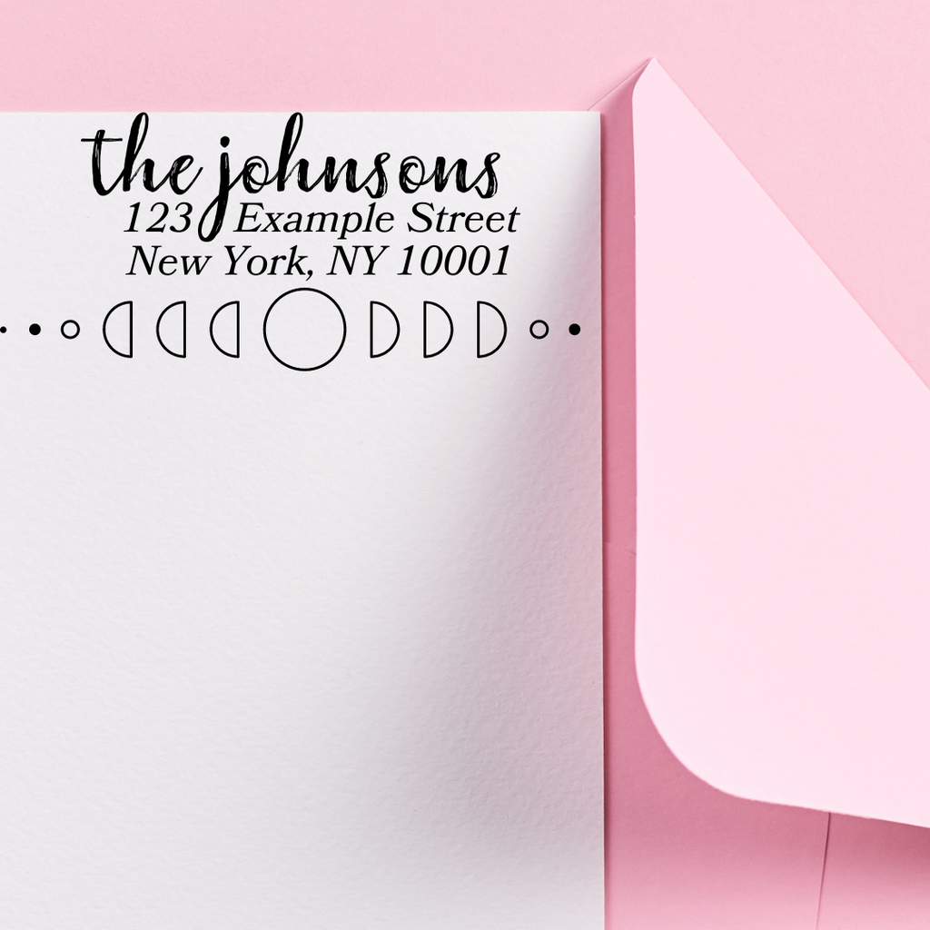 custom stamp with "the johnsons" on a white card and pink envelope