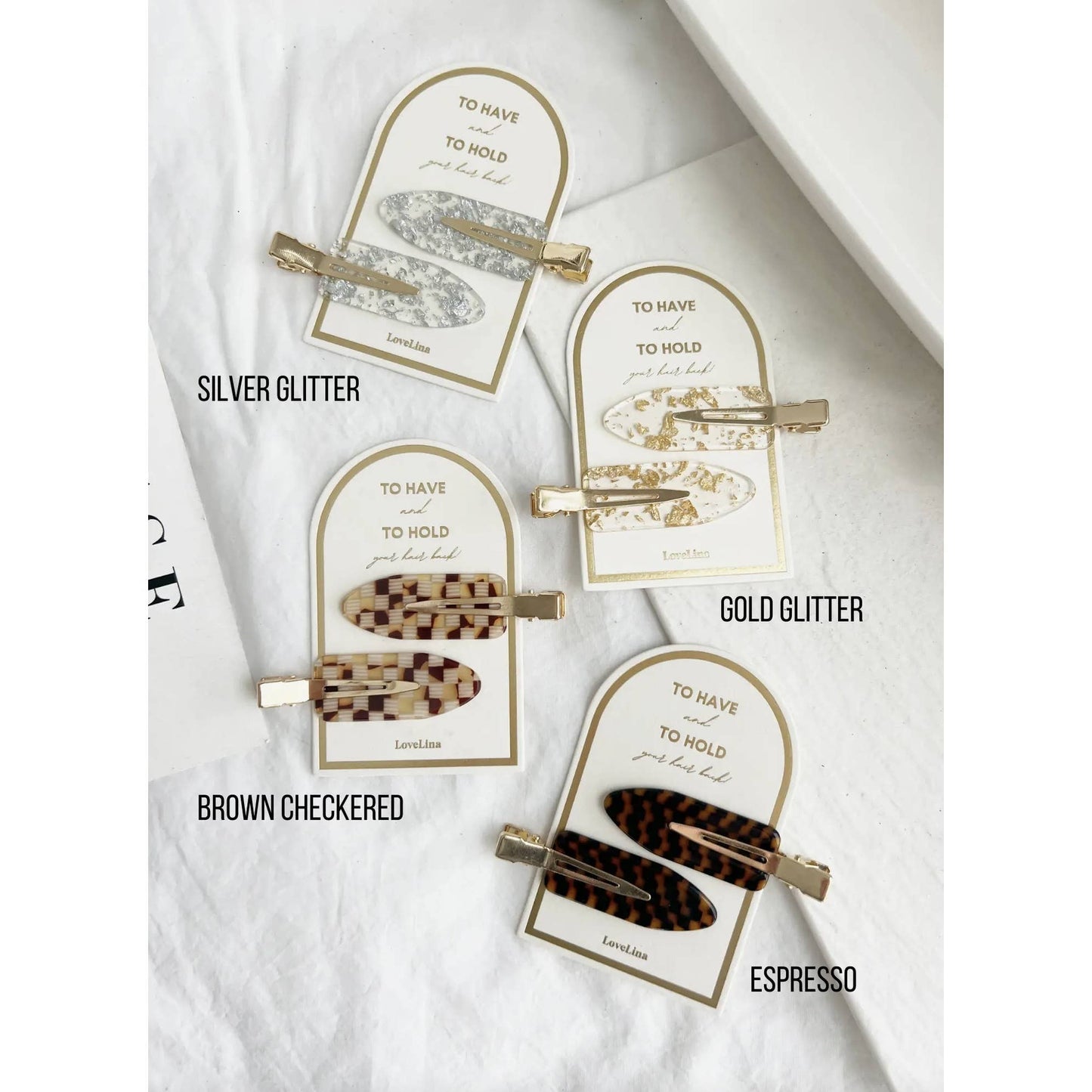 Crease free hair clips ona. gold and white backing that says "To Have and To Hold Your Hair Back"