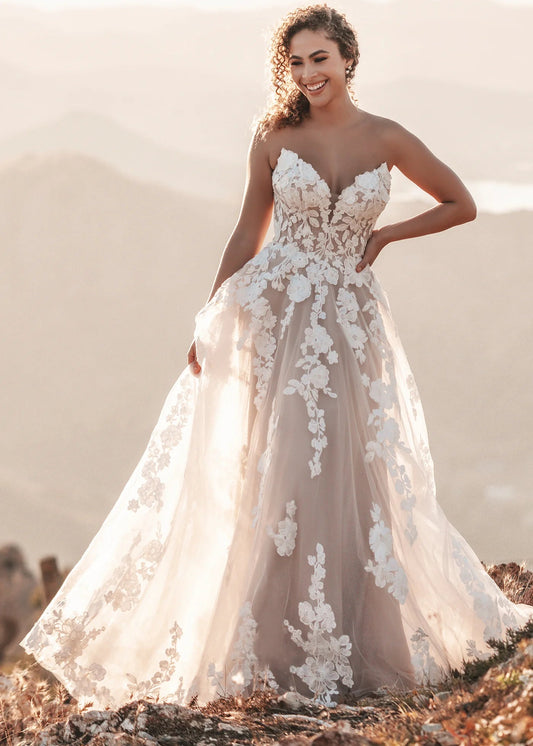 Finished with a pair of coordinating detachable sleeves, this shimmering, A-line tulle gown features soft matte lace appliques throughout.