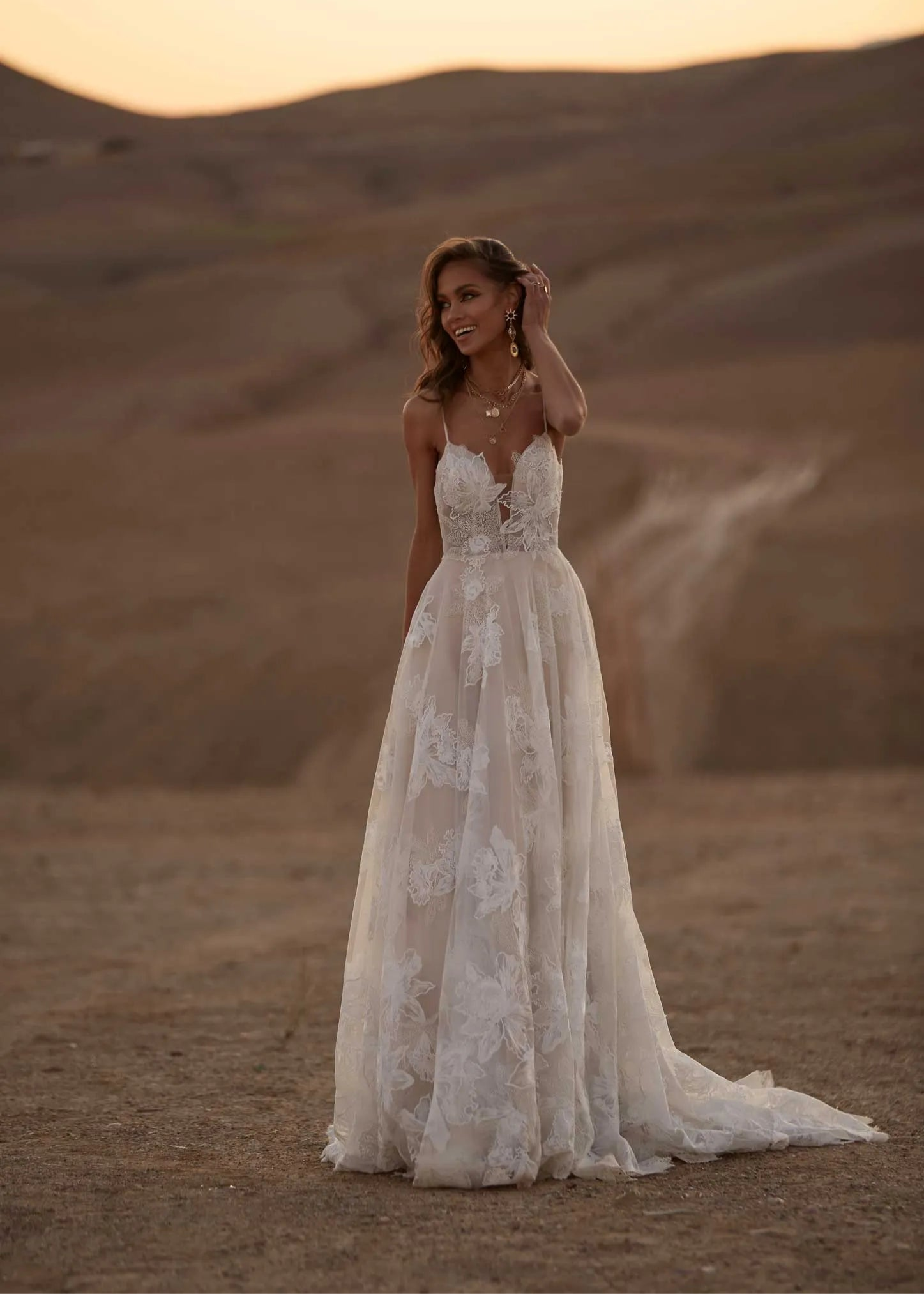 Young woman wearing a floral a line wedding dress, full body front view