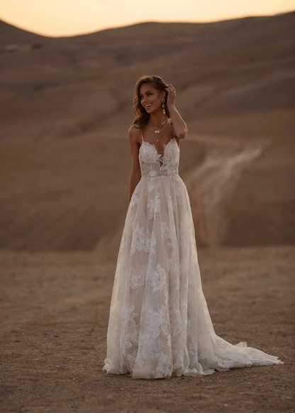 Young woman wearing a floral a line wedding dress, full body front view