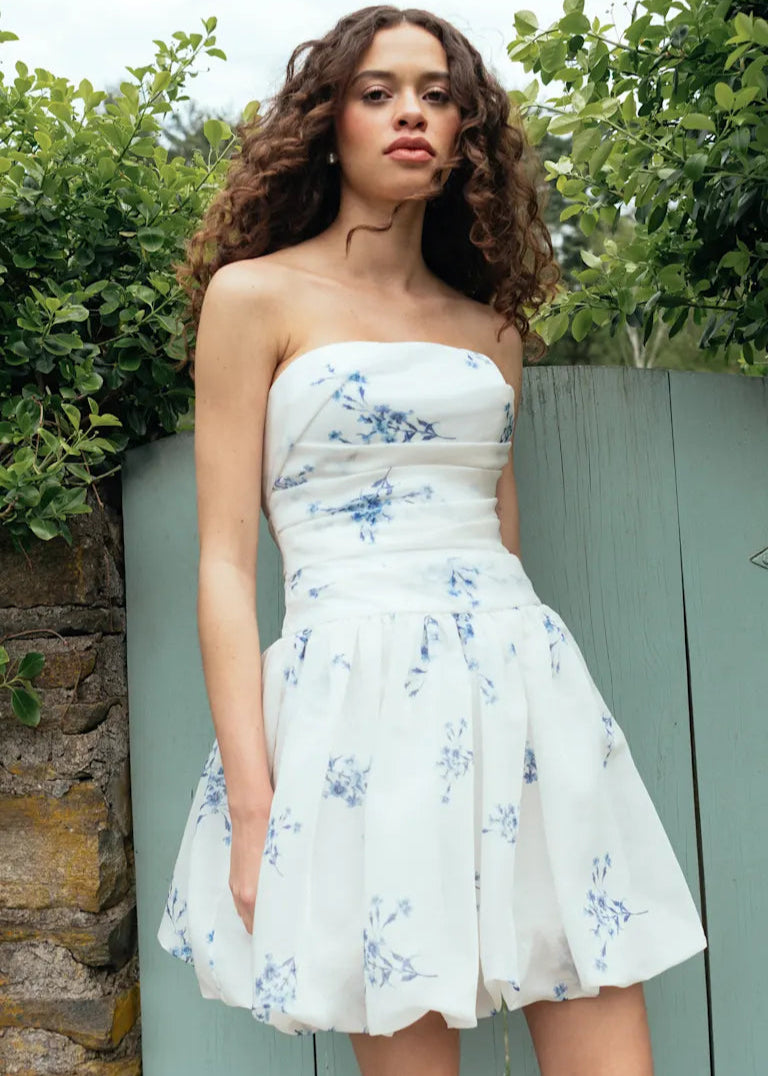 Woman wearing Ada by Jenny Yoo, a bubble hem white mini dress with blue florals