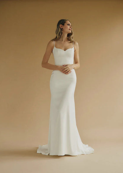 A fitted satin wedding gown with a sweetheart bodice and buttons down the back - full body view