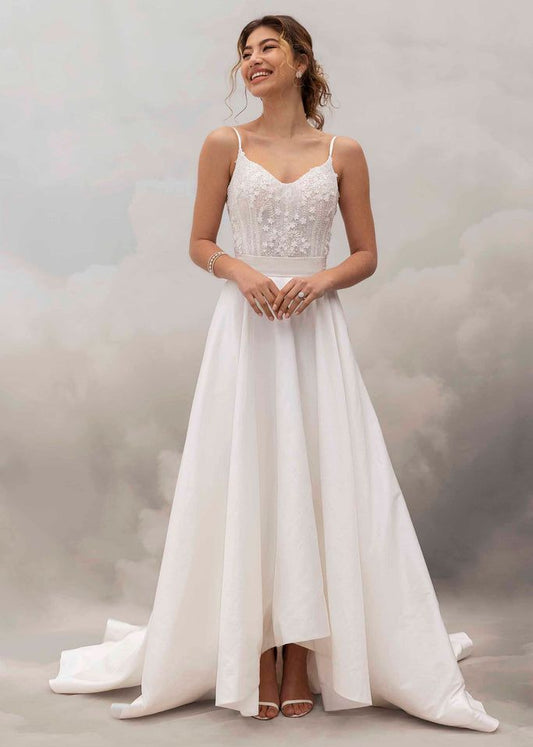 Woman wearing a white wedding dress with a soft background
