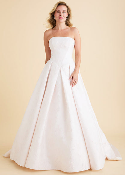  A strapless gown of rose jacquard. Angled seams on the bodice follow the line of the Basque waist. Crisp inverted box pleats add volume to the skirt and chapel train. 