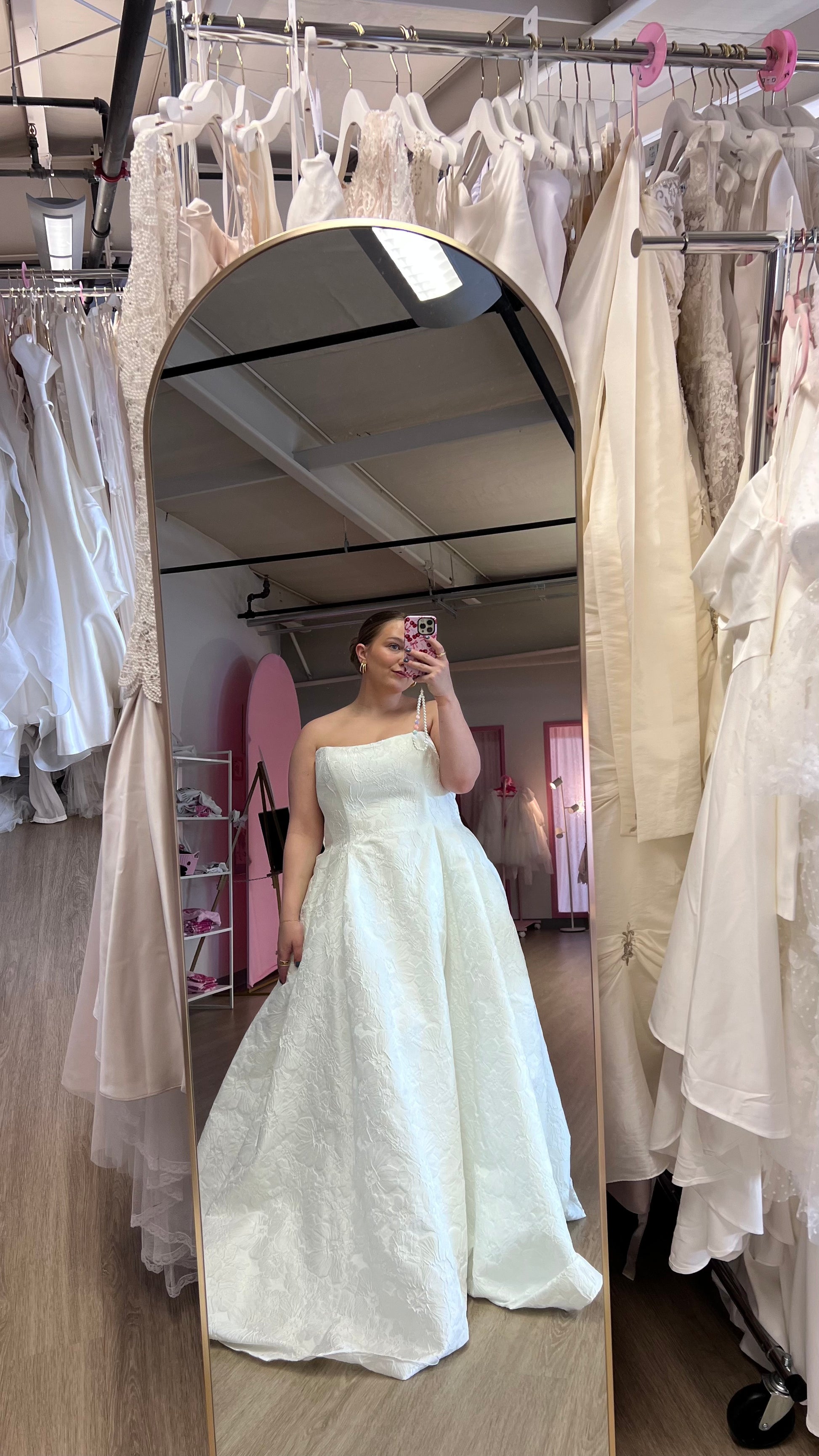 Lizzie wearing the Barrie wedding gown, strapless cat eye neckline plus size wedding dress in Ottawa featuring a brocade/jacquard neckline
