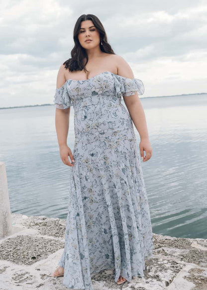 Featuring a sleek scoop neckline, and draped off the shoulder sleeves, the fitted skirt yoke shows off your curves beautifully while the full skirt flounce offers beautiful movement.