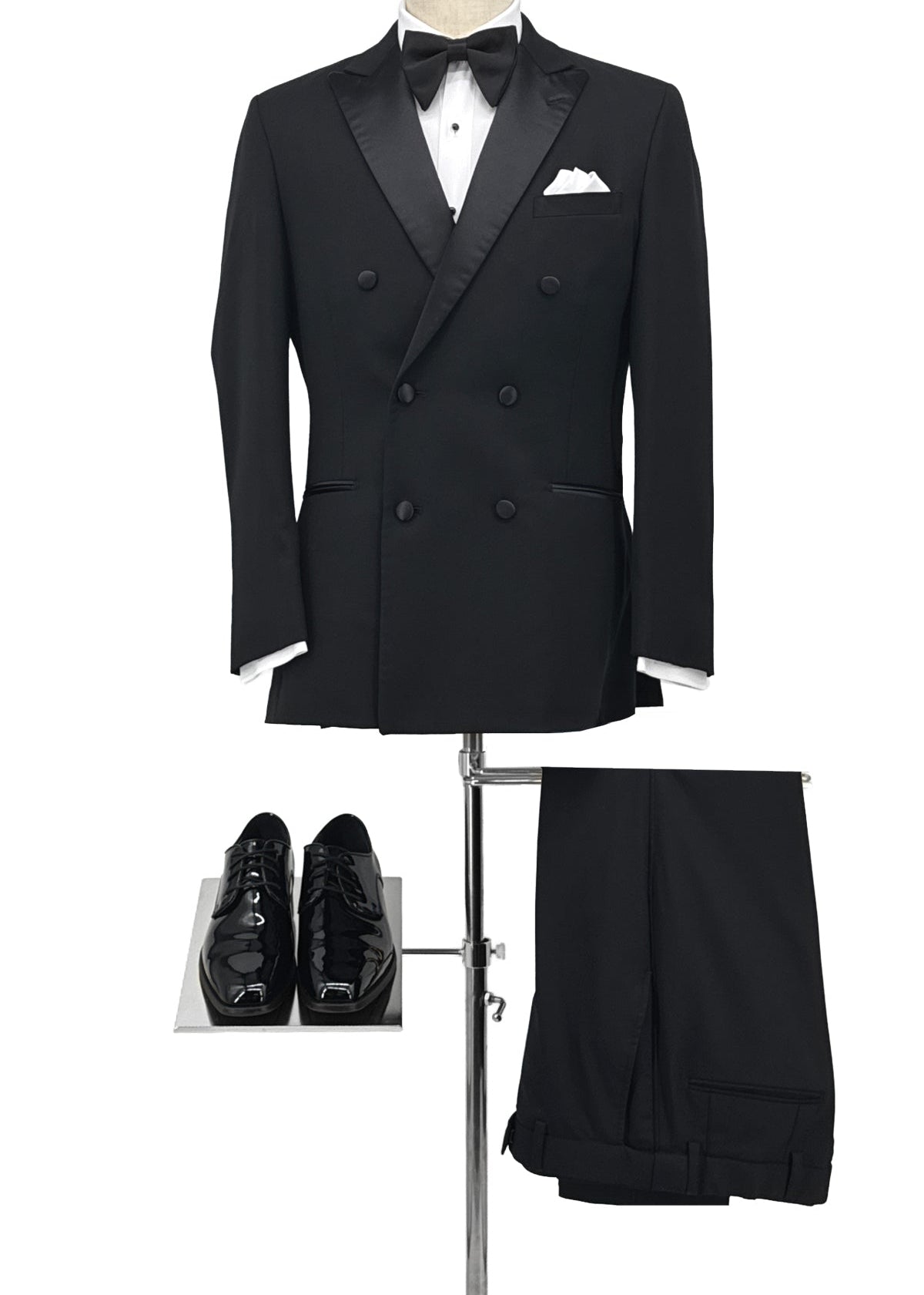 Black double breasted six button jacket with patent shoes and black pants.