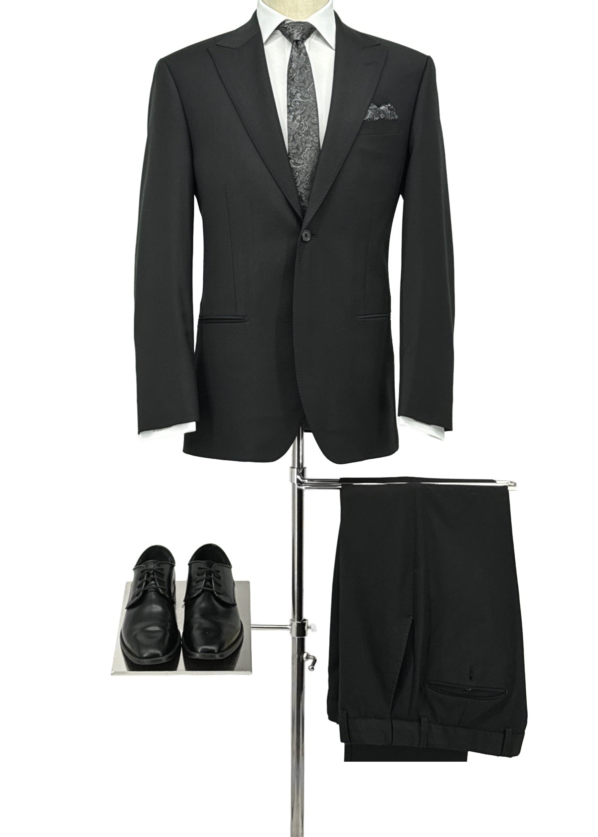 Black suit with tie, shoes, and pants on a white background