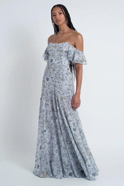 Featuring a sleek scoop neckline, and draped off the shoulder sleeves, the fitted skirt yoke shows off your curves beautifully while the full skirt flounce offers beautiful movement.