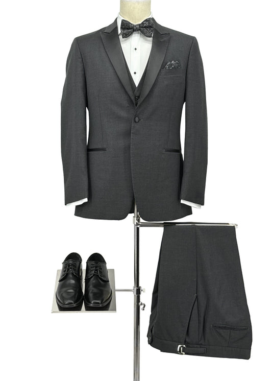 Gray tuxedo with bow tie, white shirt, black shoes, and pants on a stand against a white background.