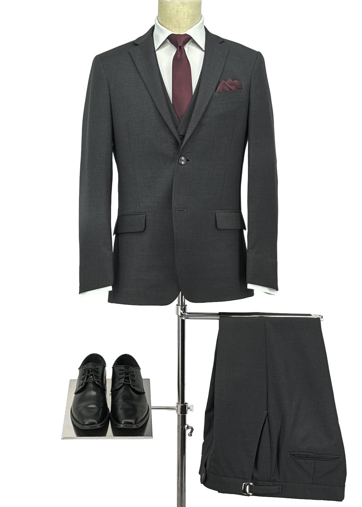Gray suit with a red tie, pocket square, and shoes on a white background