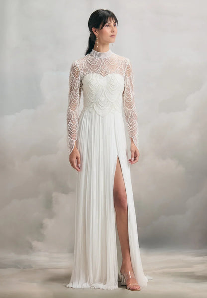 Model Bride wearing a full-length Chelton Gown is an exquisite combination of intricate pearl scalloped tulle, and gathered 100% silk tulle over eco-satin lining. 