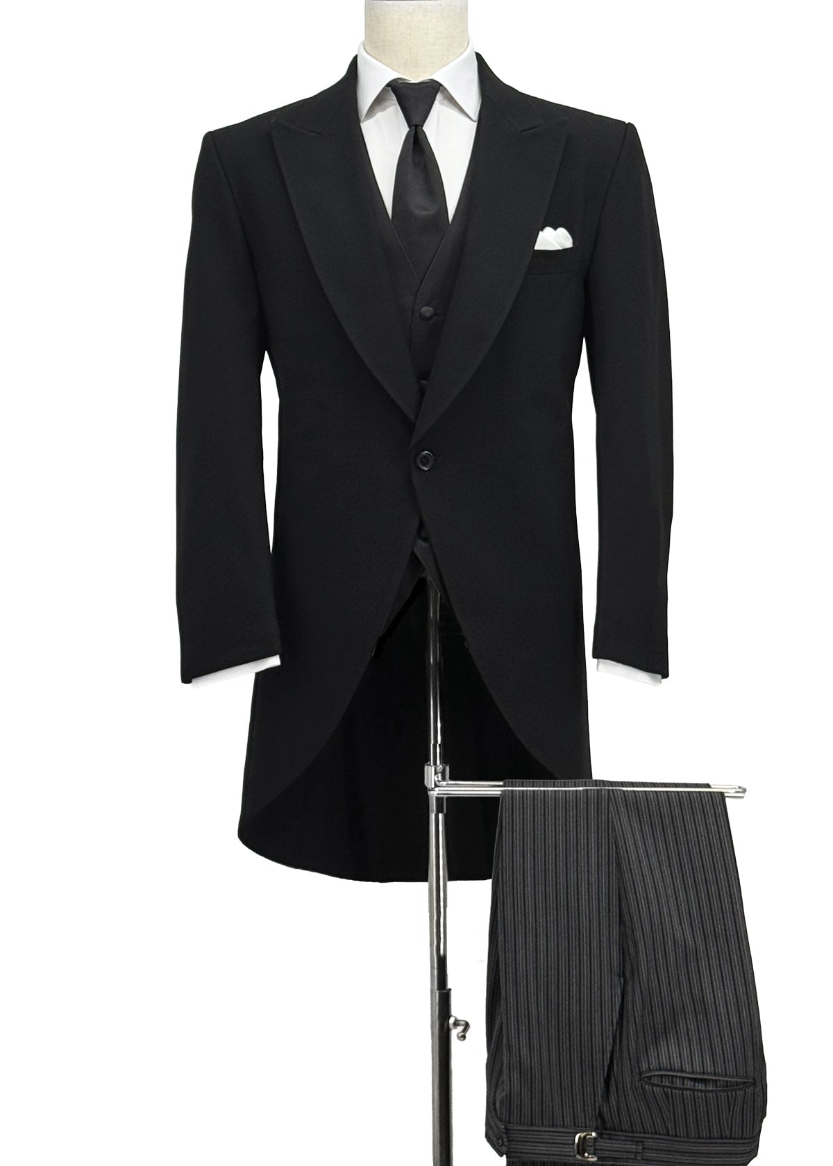 Cutaway black tuxedo jacket with charcoal striped pants, black tie and white pocket square.