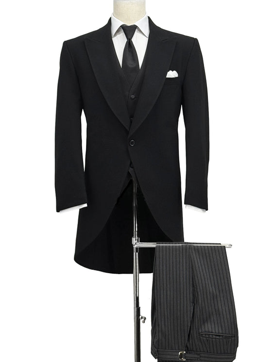 Cutaway black tuxedo jacket with charcoal striped pants, black tie and white pocket square.