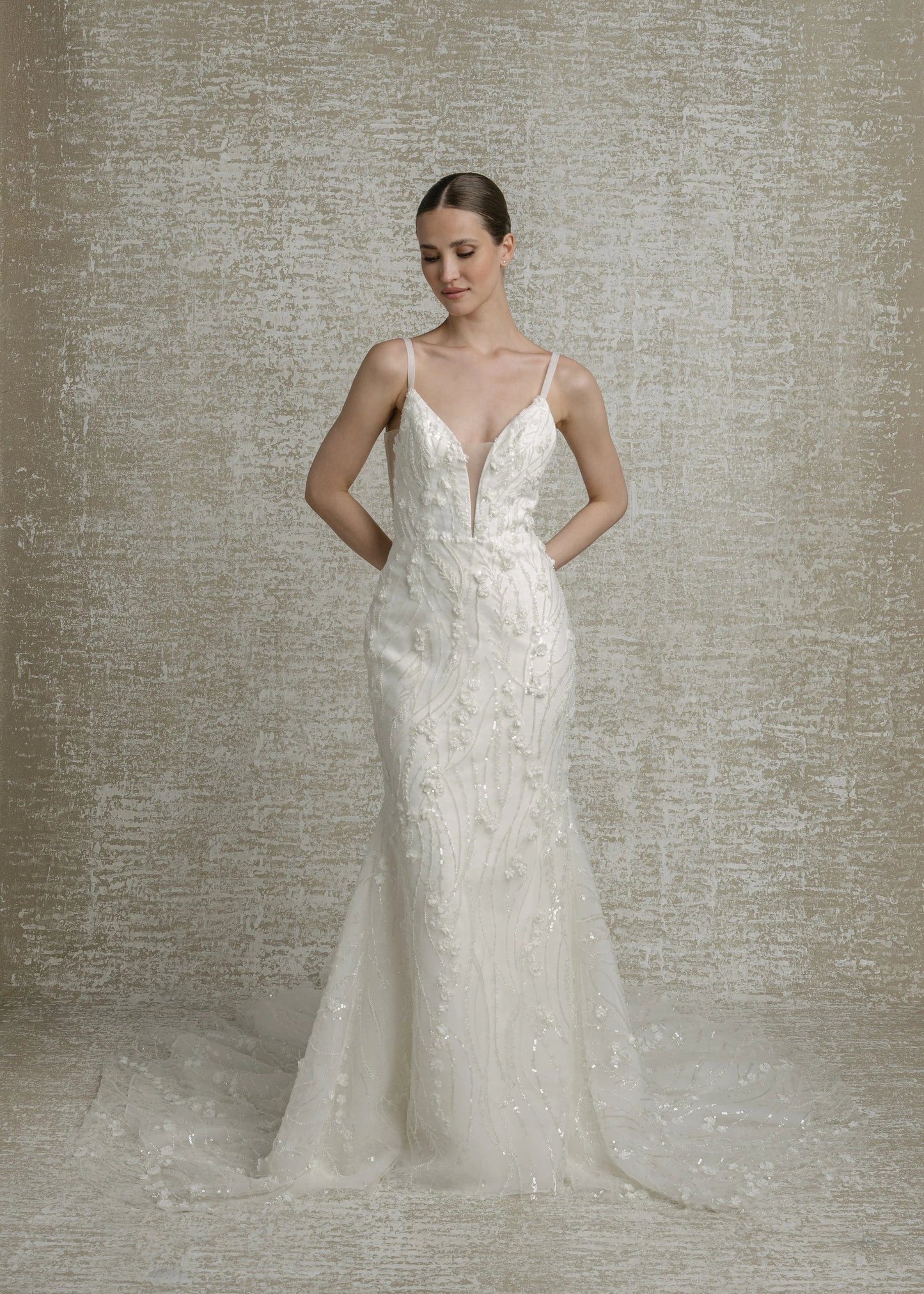 All over beaded 3D floral trailing sequinned lace, deep V neckline, thin straps, illusion cutouts under arms, fit to flare, low V back, zip closure with decorative buttons, chapel train.