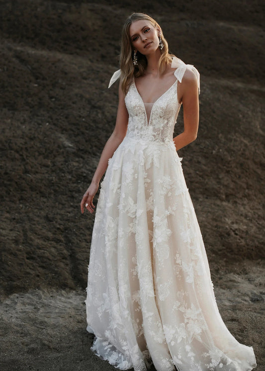 Bonquets of dimensional lace blossoms cover Helga's sparking tulle overskirt.