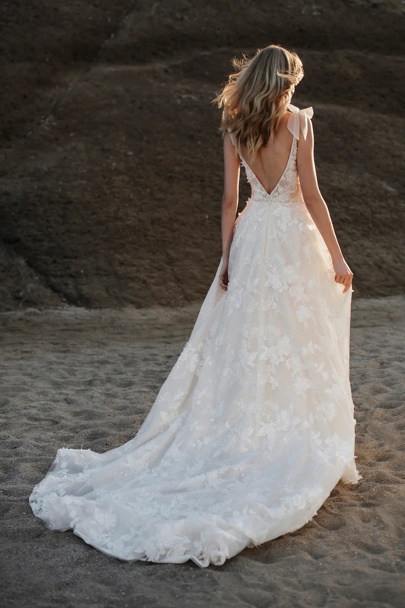 Bonquets of dimensional lace blossoms cover Helga's sparking tulle overskirt.