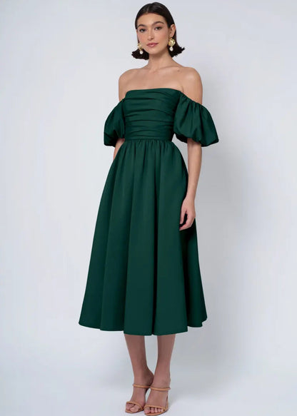 The Regina dress in our luxurious faille is a fashionable and&nbsp;versatile&nbsp;choice for any occasion. It boasts a pleated bodice with a streamlined, straight strapless neckline, removable puff sleeves, a playful midi-length dirndl skirt, and everyone’s favorite — pockets!