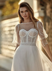 Young woman wearing a wedding dress with a full skirt, outlined bust and puffy sleeves - close up front view