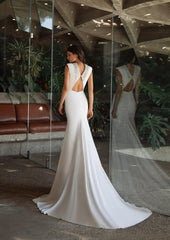 Model wearing Kerr by Pronovias - a high neck fitted wedding dress with a beaded neckline - full body back view