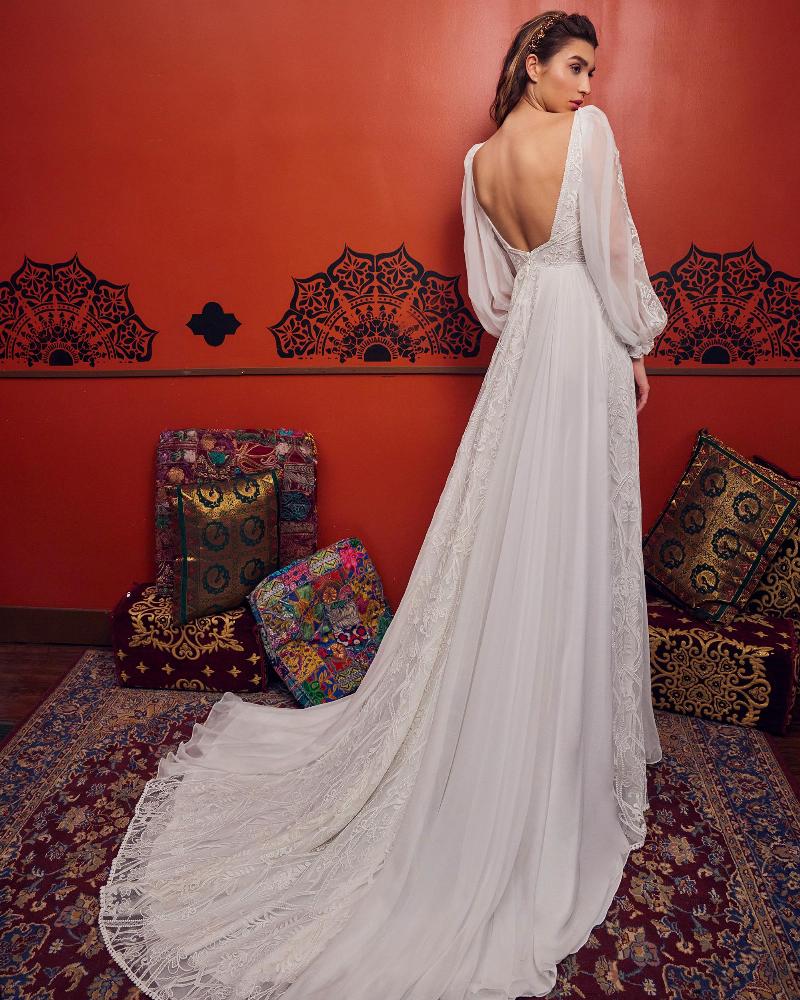 Woman wearing a longsleeve wedding dress full lace back view