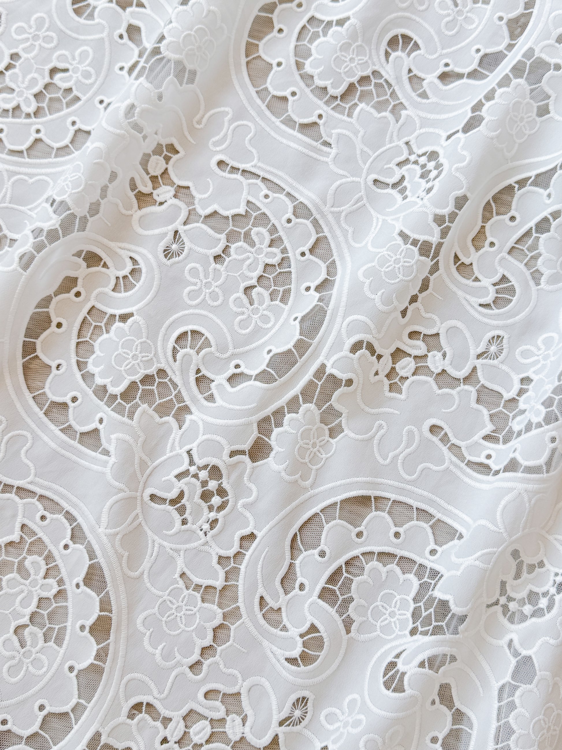 Closeup of the floral ornament lace of the LARKIN wedding dress