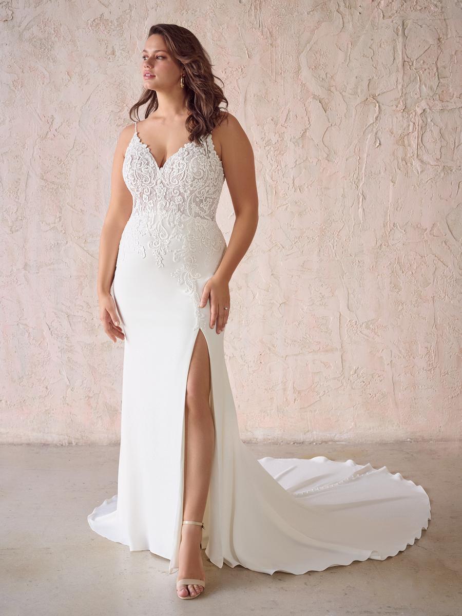 Sheathe lace and crepe wedding dress on a curvy model that's available at Never Knew I needed in Ottaawa.