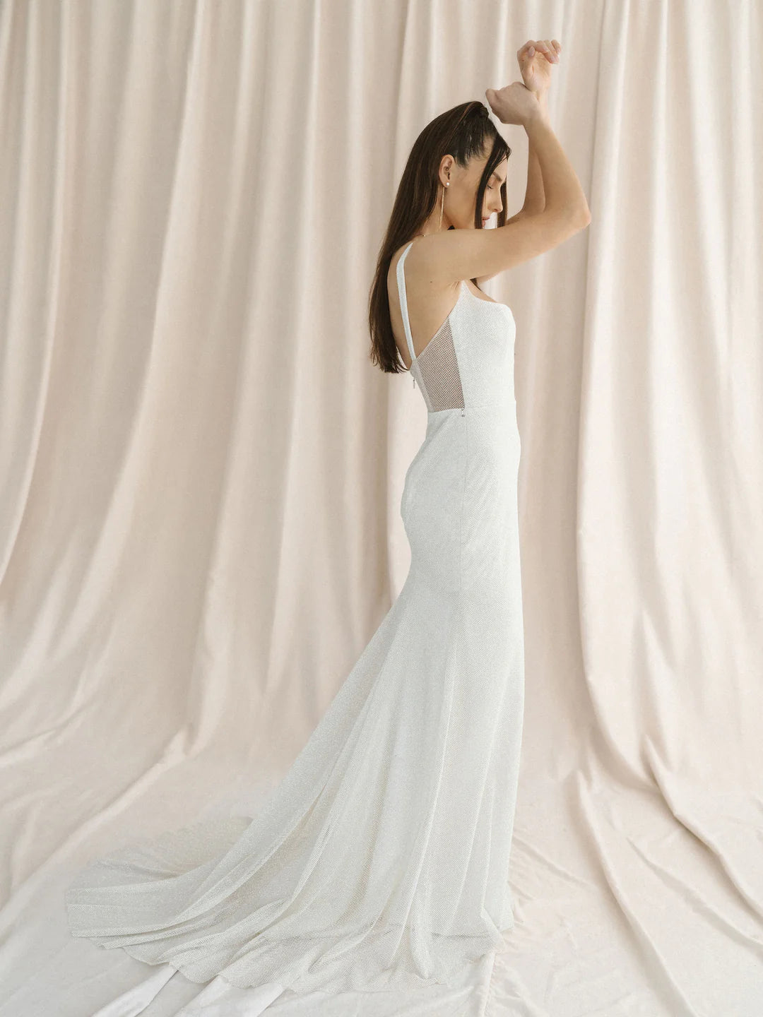 A sparkly champagne tulle wedding gown with a unique u-wire neckline and illusion back. - full body side view