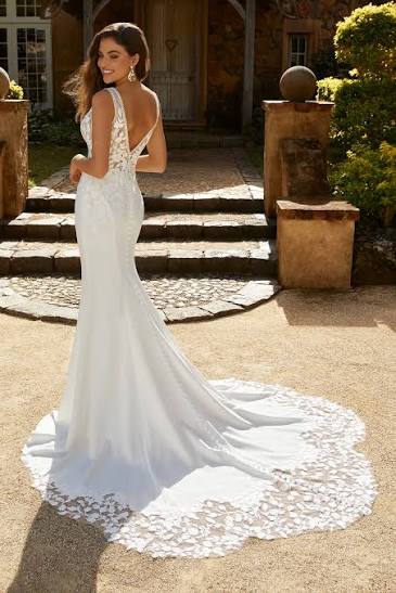 Model showing off the  low back V of Maren by Sophia tolli fit and flare wedding dress in crepe and lace at NKIN bridal outlet in Ottawa