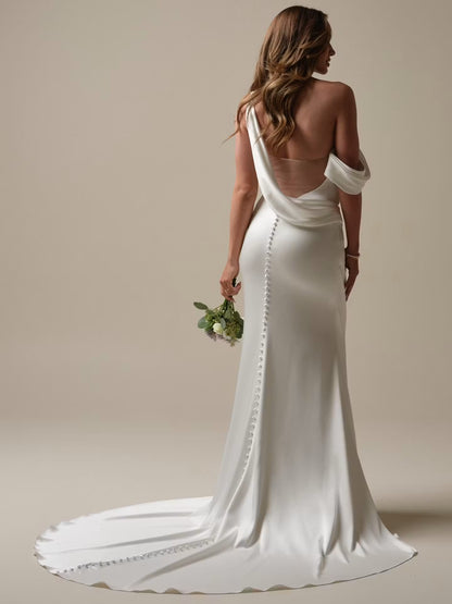 Plunging illusion V-back with draped cowl detail with an asymmetrical zipper closure with covered buttons trailing to hem at NKIN in Ottawa