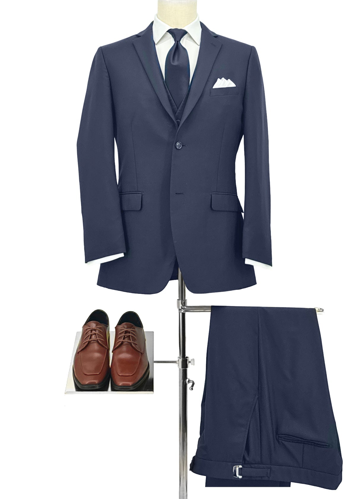 Navy suit jacket & pant with navy tie, white pocket square and tan square shoes.