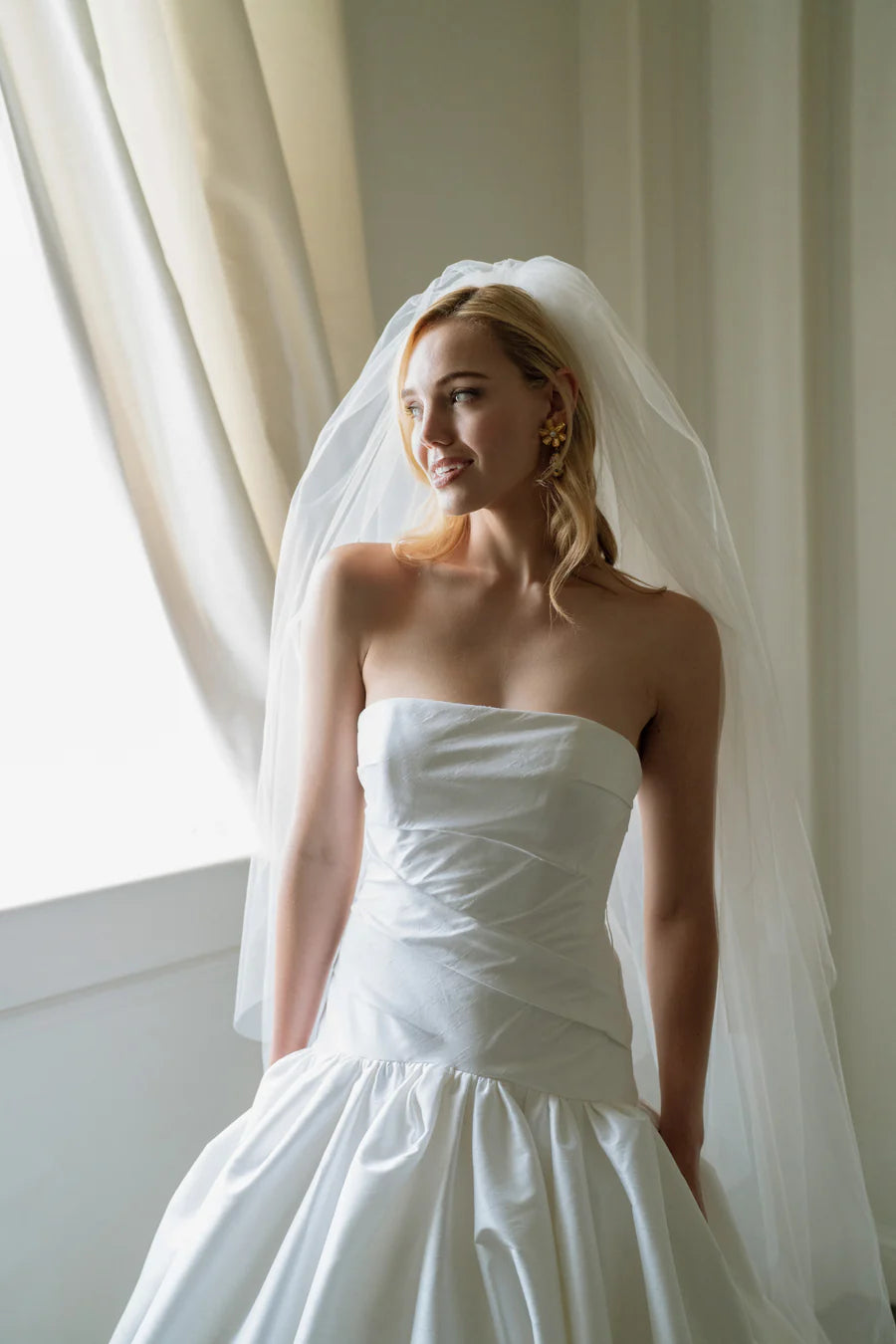 The show stopping Parvati gown with a dropped waist ballgown is what bridal dreams are made of. Corset construction for security and a flattering bodice. With a straight neckline, and oh did we mention, she has pockets!