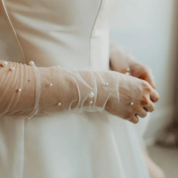 Woman wearing beaded tulle fingerless gloves