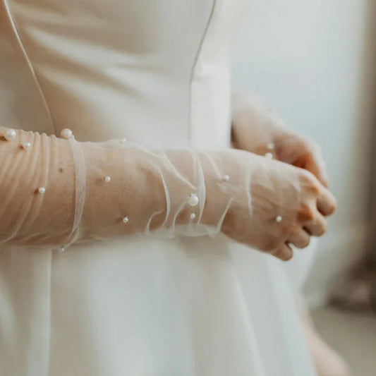 Woman wearing beaded tulle fingerless gloves