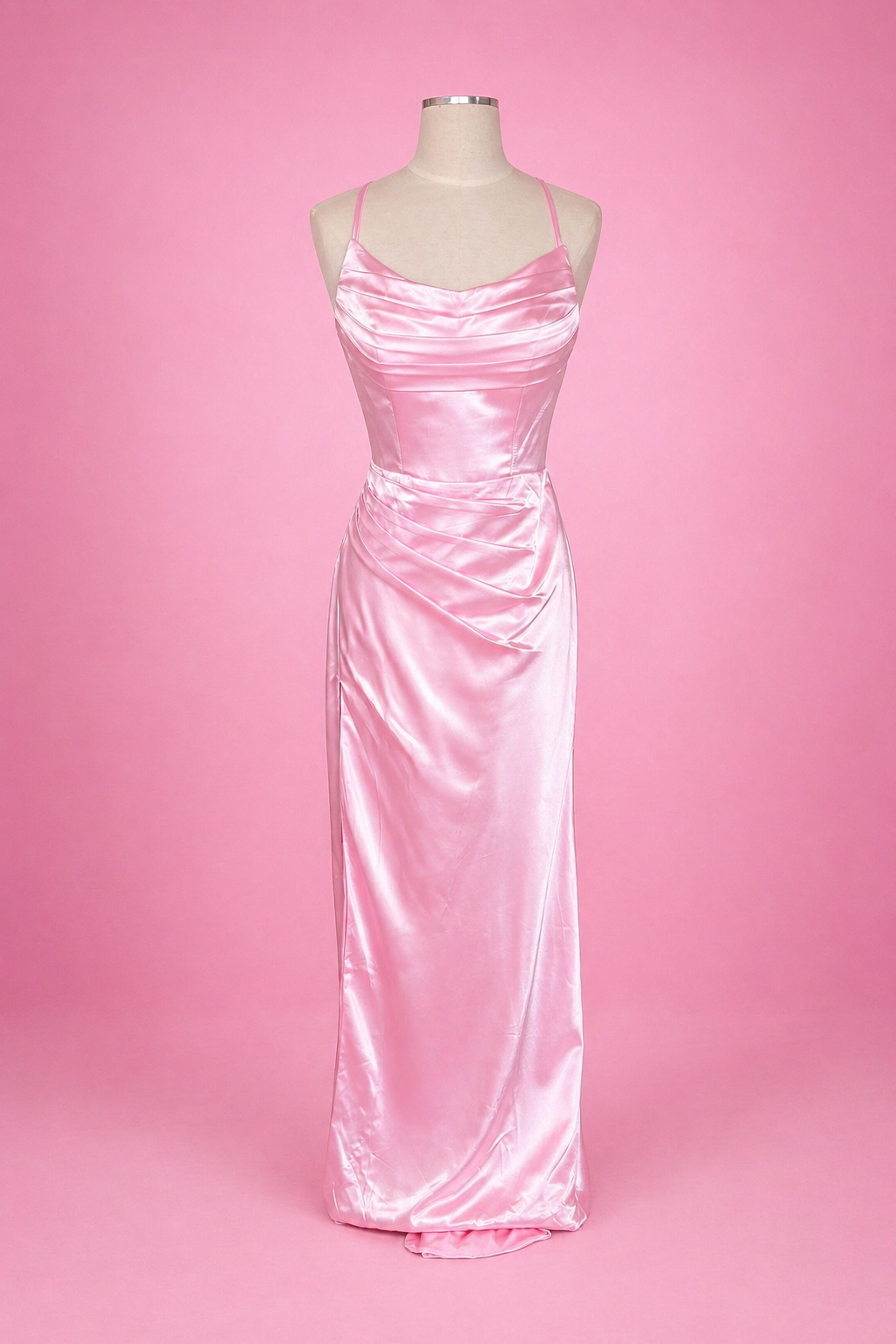 Pink satin evening gown on a mannequin against a pink background