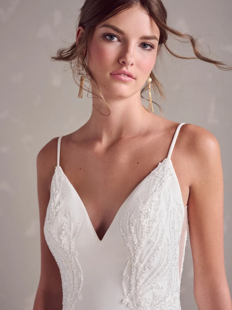 Woman wearing a white lace dress against a neutral background