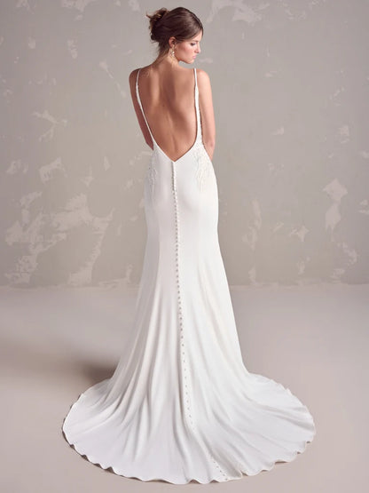 White wedding dress with open back on a neutral background
