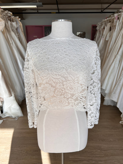 White lace garment on a mannequin against a neutral background