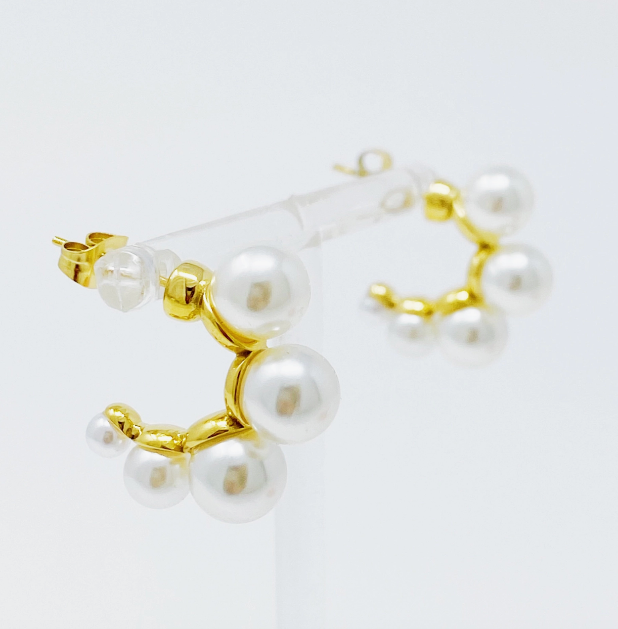 Close up photo of small gold hoops with pearls