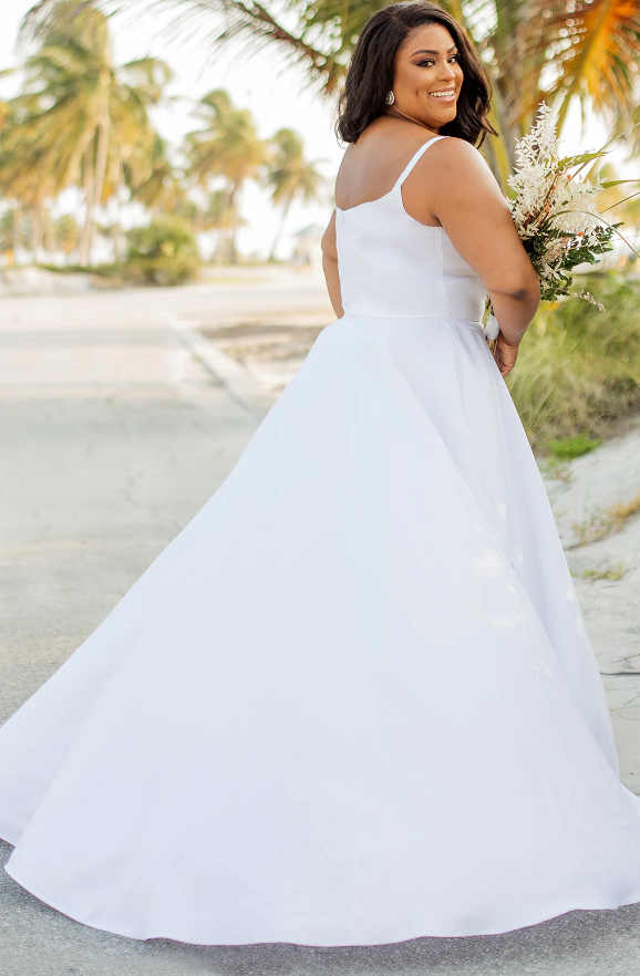 Woman wearing a plain wedding dress in white back view