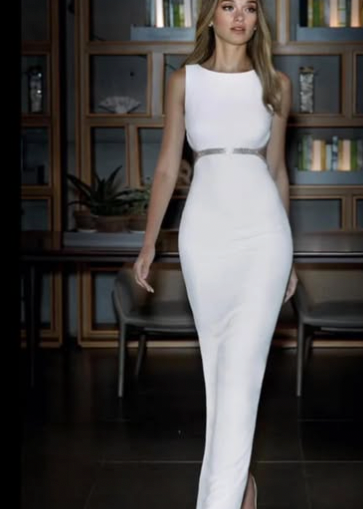 Young woman wearing a halter neck white wedding dress with a belt