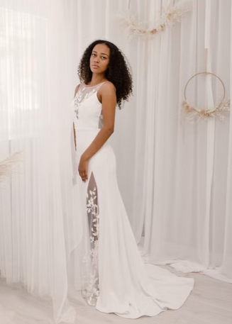 A breathtaking high neck dress with floral appliques cascading down the body followed by a high-slit and low scoop back - full body front view