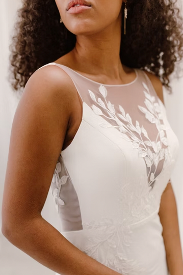 A breathtaking high neck dress with floral appliques cascading down the body followed by a high-slit and low scoop back - close up front view