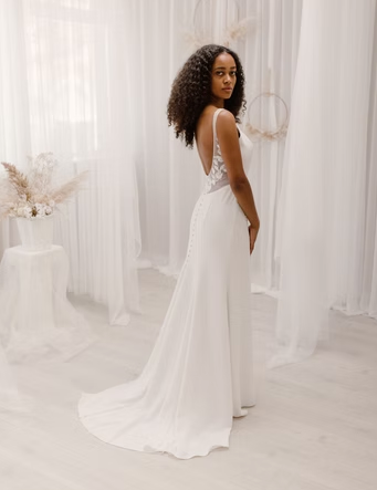 A breathtaking high neck dress with floral appliques cascading down the body followed by a high-slit and low scoop back - full bdoy back view