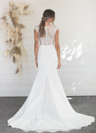  A sheath crepe gown with a modified scoop neckline topped with a delicate and soft chantilly lace that softly covers the neck and back, allowing the skin to be showcased under the stunning lace - full body back view
