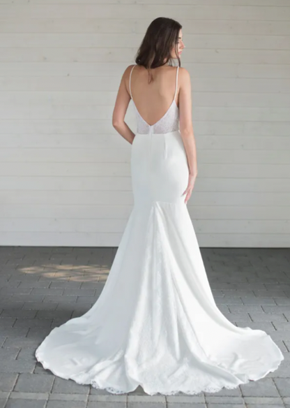 a captivating plunging v-neckline, a flattering fit and flare skirt, and delicate lace detailing throughout - full body back view