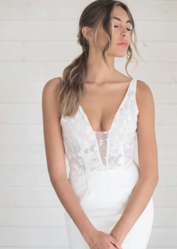 Elizabeth features a classic, deep plunging neckline and a very flattering sheath skirt. Elizabeth features hand-sewn lace in the waistband making the transition from top to bottom very smooth. The stunning and daring low v-back elongates the body and melts effortlessly into its simple, classic train - close up front view