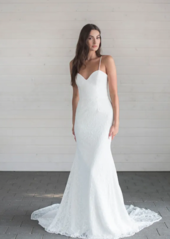 A captivating full lace fit and flare wedding gown with a sweetheart neckline, slight v-back, a beautiful long train, and a graceful godet detail - full body front view