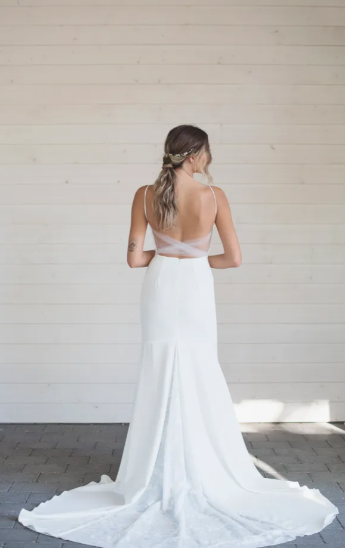 A lace covered plunging sweetheart neckline with illusion tulle creates a super flattering tailored bodice to pair with a sheath silhouette - full body back view